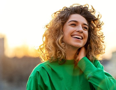 Smiling woman with city buildings in background