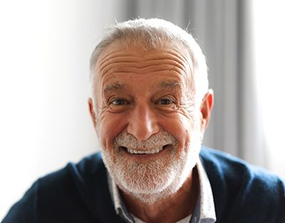 Bearded senior man smiling at home