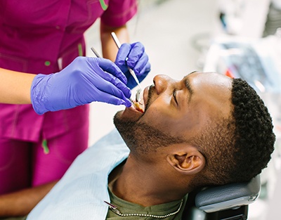 Dentist examining patient's teeth